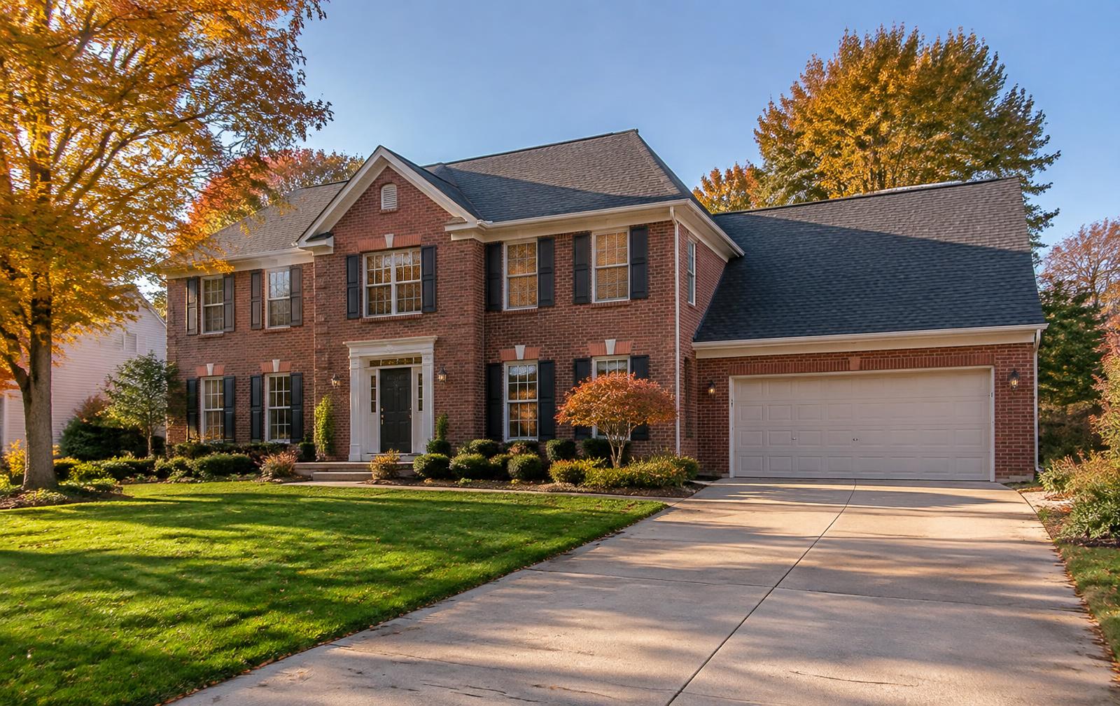 Well-kept brick colonial home with a clean driveway in a Metro Detroit suburb